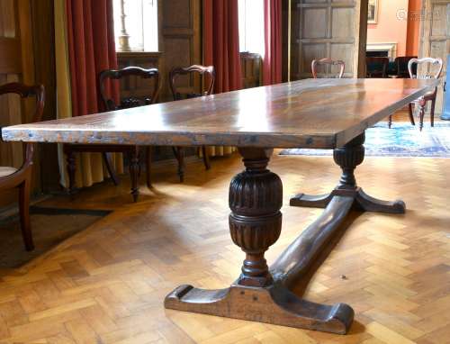 A GOOD OAK REFECTORY TABLE with two plank top, carved cup an...