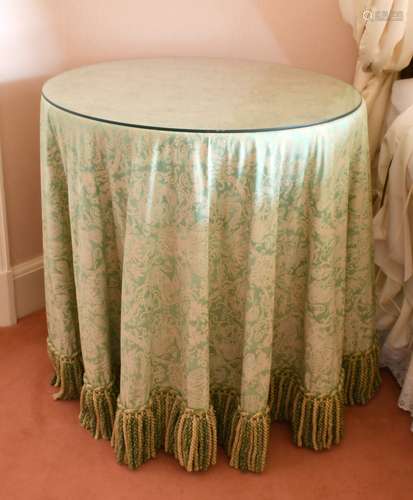 A GLASS TOP CIRCULAR TABLE with fabric cover. 2ft 4ins diame...