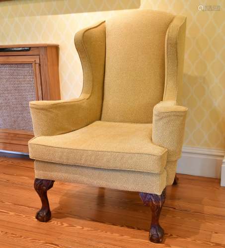 A GEORGE III STYLE MAHOGANY WING BACK ARMCHAIR, on carved ca...