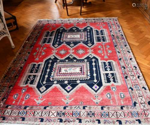 A PERSIAN WOOL RUG with two main medallions within a three-r...