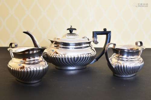 A SEMI FLUTED SILVER THREE PIECE TEA SET, comprising teapot,...