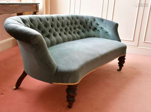 A VICTORIAN SHAPED BUTTON BACK SETTEE on turned legs and cas...