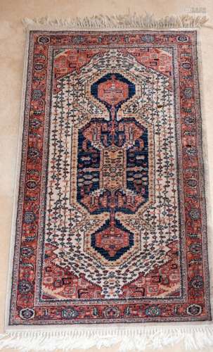 A SMALL PERSIAN RUG with large medallion. 5ft x 2ft 8ins.
