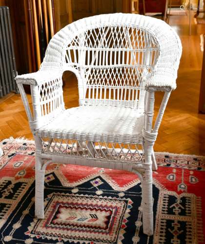 A WHITE PAINTED CANE CHAIR.