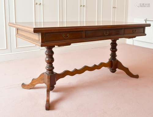 A LONG OAK TABLE with three drawers, turned supports and tri...