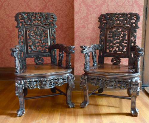 A GOOD PAIR OF CHINESE CARVED AND PIERCED ARMCHAIRS with sol...