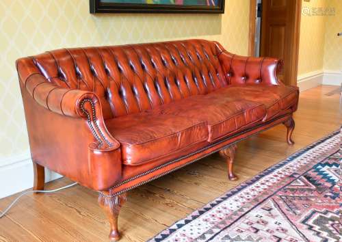 A SUPERB BUTTONED BACK LEATHER SOFA with scroll ends, on mah...