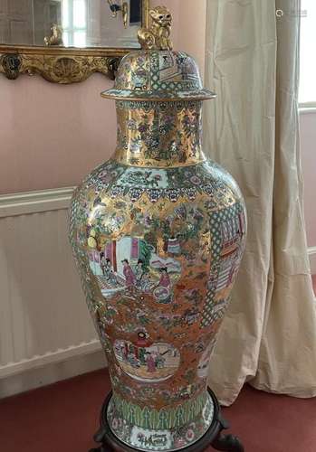 A LARGE CANTON DESIGN PORCELAIN VASE AND COVER, on a wooden ...