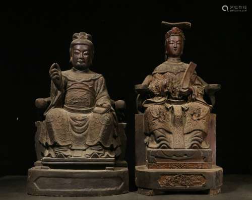 Overseas Backflow.  A Pair of Wood Bodied Seated Statues