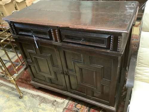 An early 18th century and later oak cupboard, with two friez...