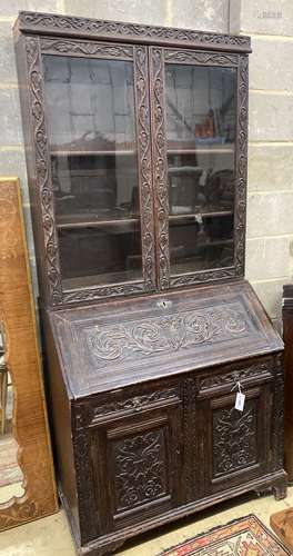 A Victorian carved oak bureau bookcase, width 94cm, depth 54...