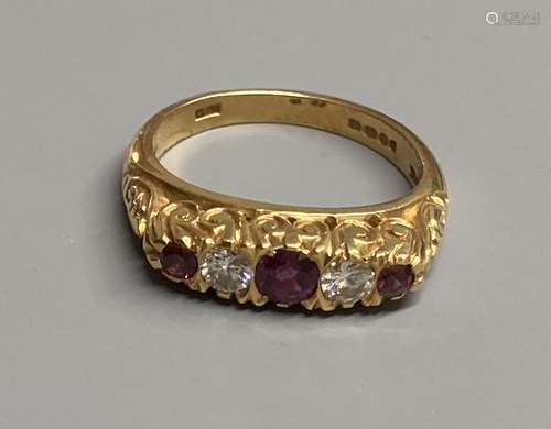 A modern Victorian style 18ct gold, three stone ruby and two...