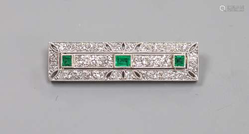 An Art Deco pierced 18ct and plat, emerald and diamond mille...