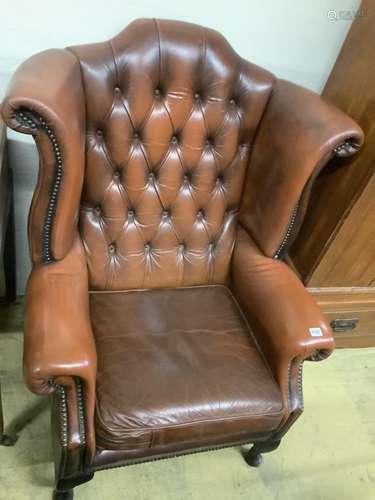 A buttoned burgundy leather wing armchair, width 86cm, depth...