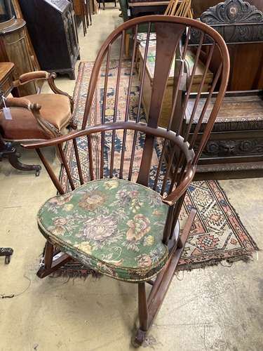 An Ercol comb back stained beech rocking chair, width 60cm, ...