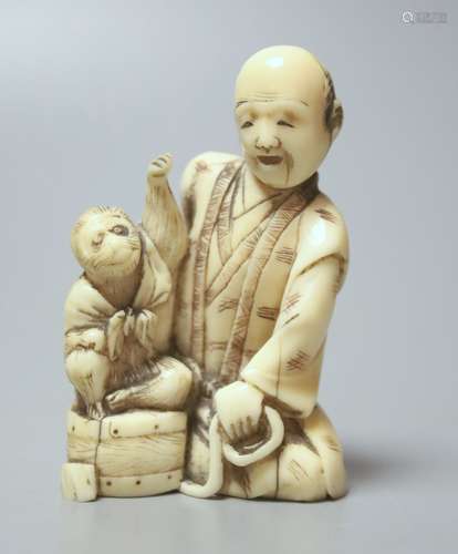 A Japanese ivory group of a man with a monkey, 19th century,...