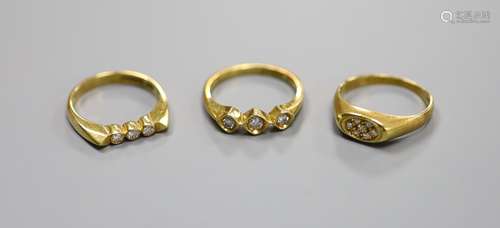 Three assorted modern 18ct gold and diamond set rings, inclu...