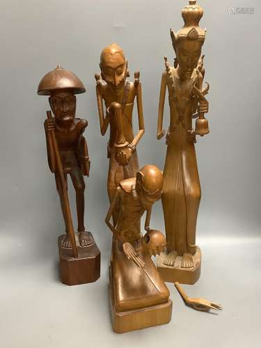 A group of three Balaris carved wood figures of mendicants a...