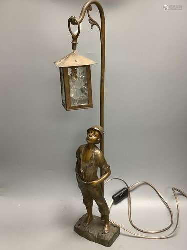 An early 20th century bronzed spelter whistling boy table la...