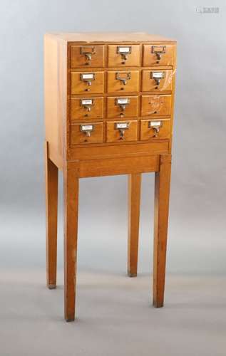 An early 20th century golden oak filing chest on stand, fitt...