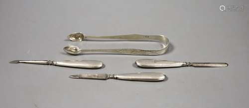 A pair of Georgian silver sugar tongs and three manicure imp...