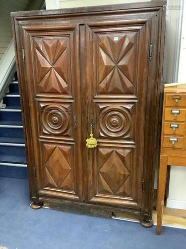 A large fruitwood double wardrobe / armoire, with twin carve...