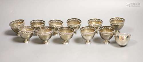 A set of twelve pierced small white metal footed cups,height...