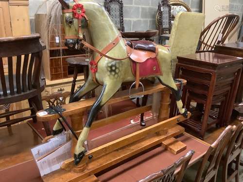 A 1920's F.H. Ayres painted wood rocking horse, on a trestle...