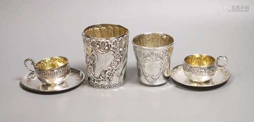 A pair of French white metal cups and saucers and two simila...