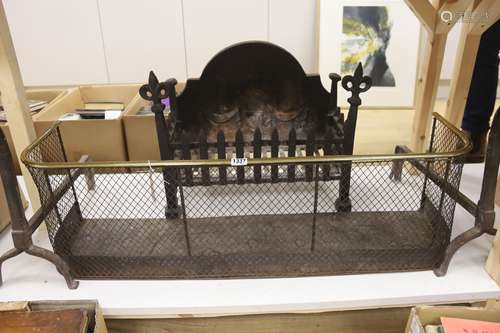 A wrought iron fire grate, a pair of fire dogs and a Regency...