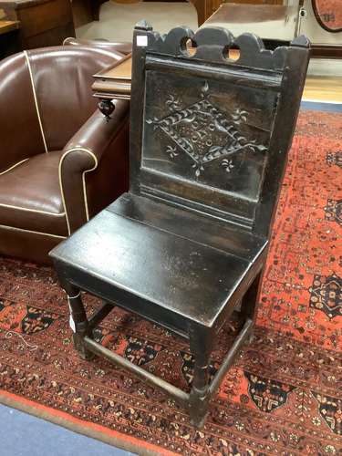 A 17th century and later oak panelled back stool with carved...