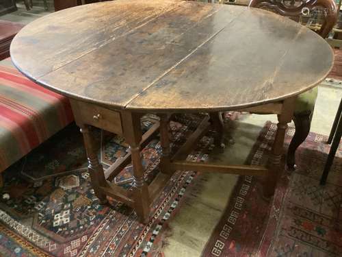 A mid 18th century oak oval topped gate leg dining table, fi...