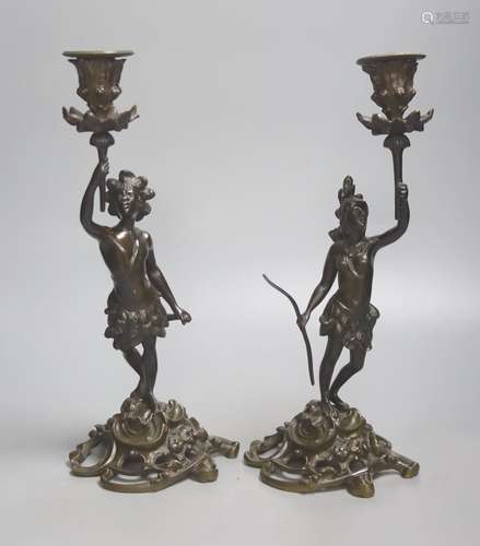 A pair of 19th century French bronze candlesticks, modelled ...