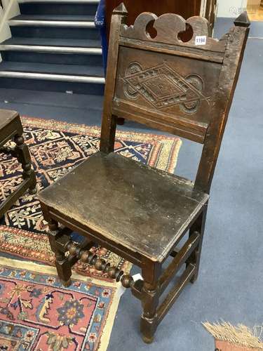 An 17th century oak back stool with lozenge carved decoratio...