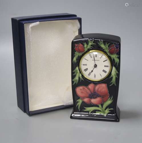 A Moorcroft pottery Anemone pattern quartz clock, height 15....