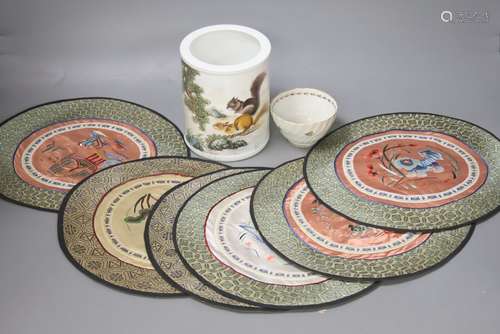 A Chinese porcelain brush pot, various embroidered silk mats...