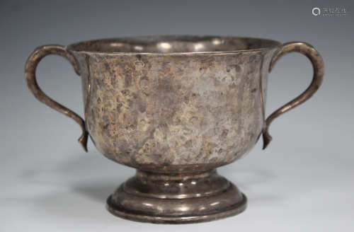 A silver two-handled cup, the flared circular bowl flanked b...