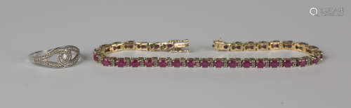 A silver gilt, ruby and colourless gem set line bracelet on ...