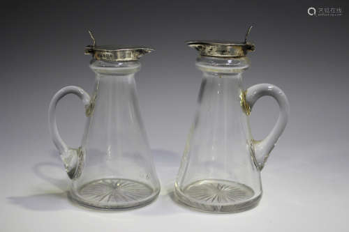 A pair of George V silver and clear glass whisky tots, each ...