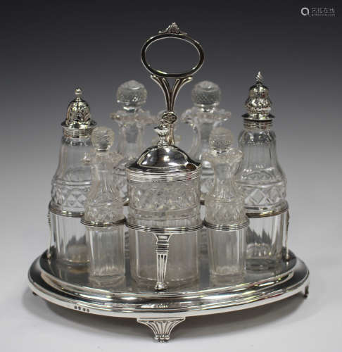 A George III silver oval eight-bottle cruet stand with centr...