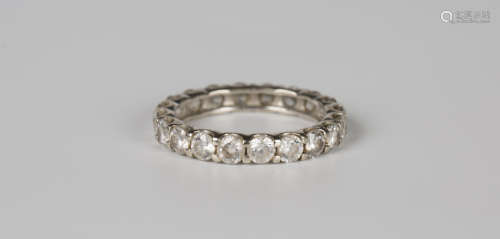 A white gold and colourless gem set eternity ring, detailed ...