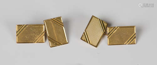 A pair of 9ct gold rectangular cufflinks with engine turned ...