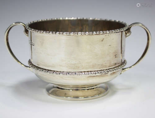 A George V silver two-handled bowl with bead and reel rim, o...