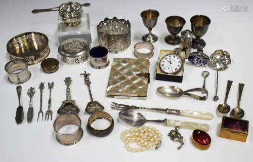 A small collection of silver items, including four napkin ri...