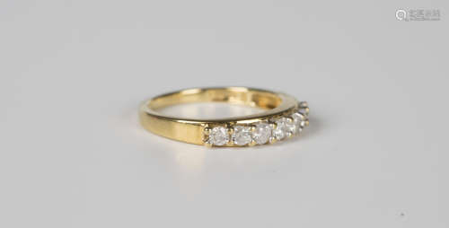 An 18ct gold and diamond seven stone half-hoop ring, mounted...