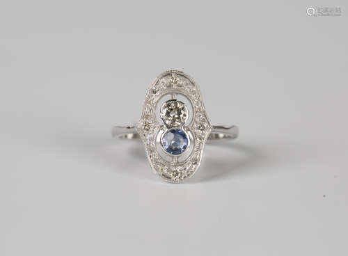 A white gold, sapphire and diamond ring, collet set with the...