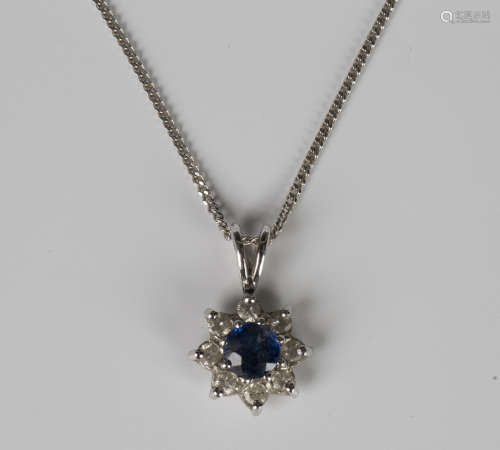 An 18ct white gold, sapphire and diamond nine stone cluster ...