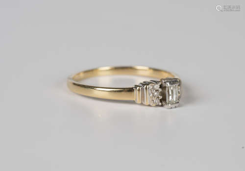 An 18ct gold ring, mounted with a millennium cut diamond bet...