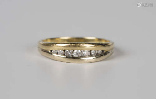 An 18ct gold and diamond ring, channel set with a row of sev...