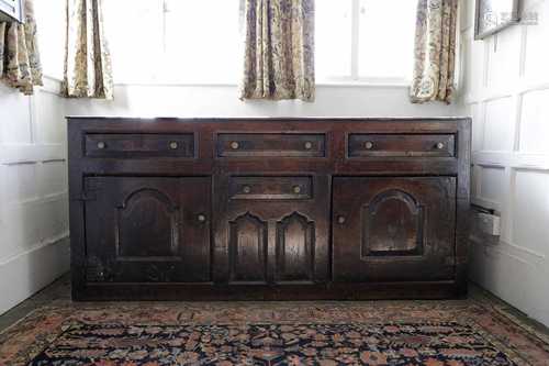 An oak dresser with cupboards and drawers,